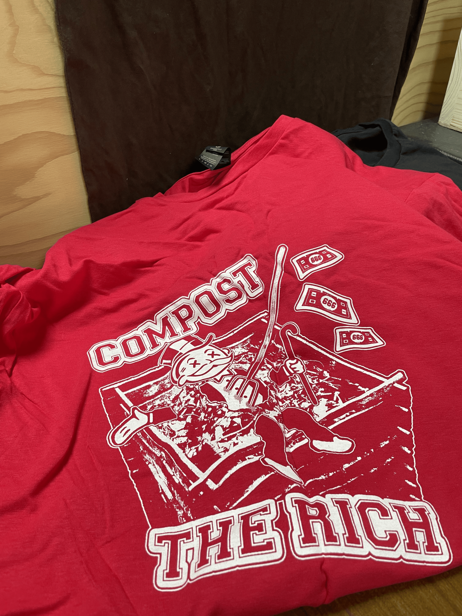 red t-shirt with the text: compost the rich